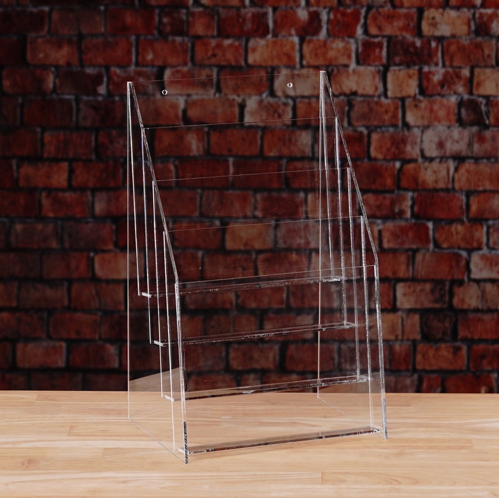 A transparent plastic rack with Fout shelves for displaying items.